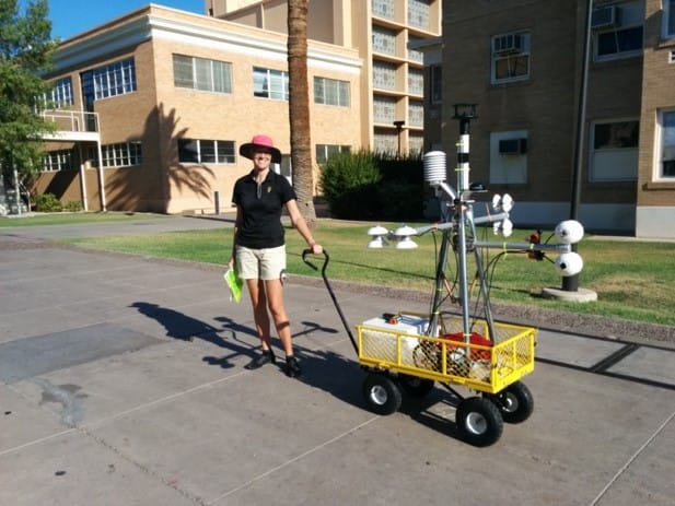 Woman outside with thermal equipment on campus