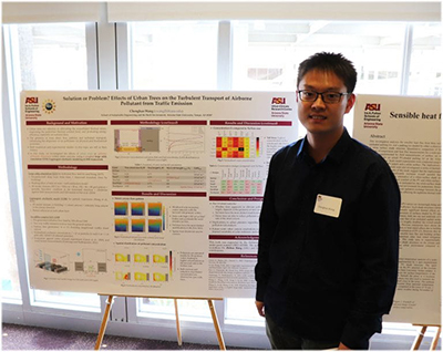 Young man standing in front of a presentation board