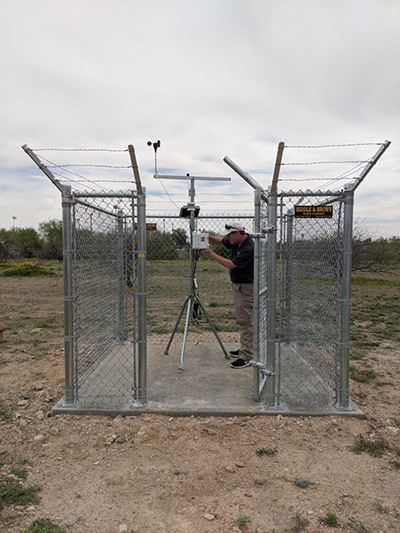 Man inside a small fence with a camera