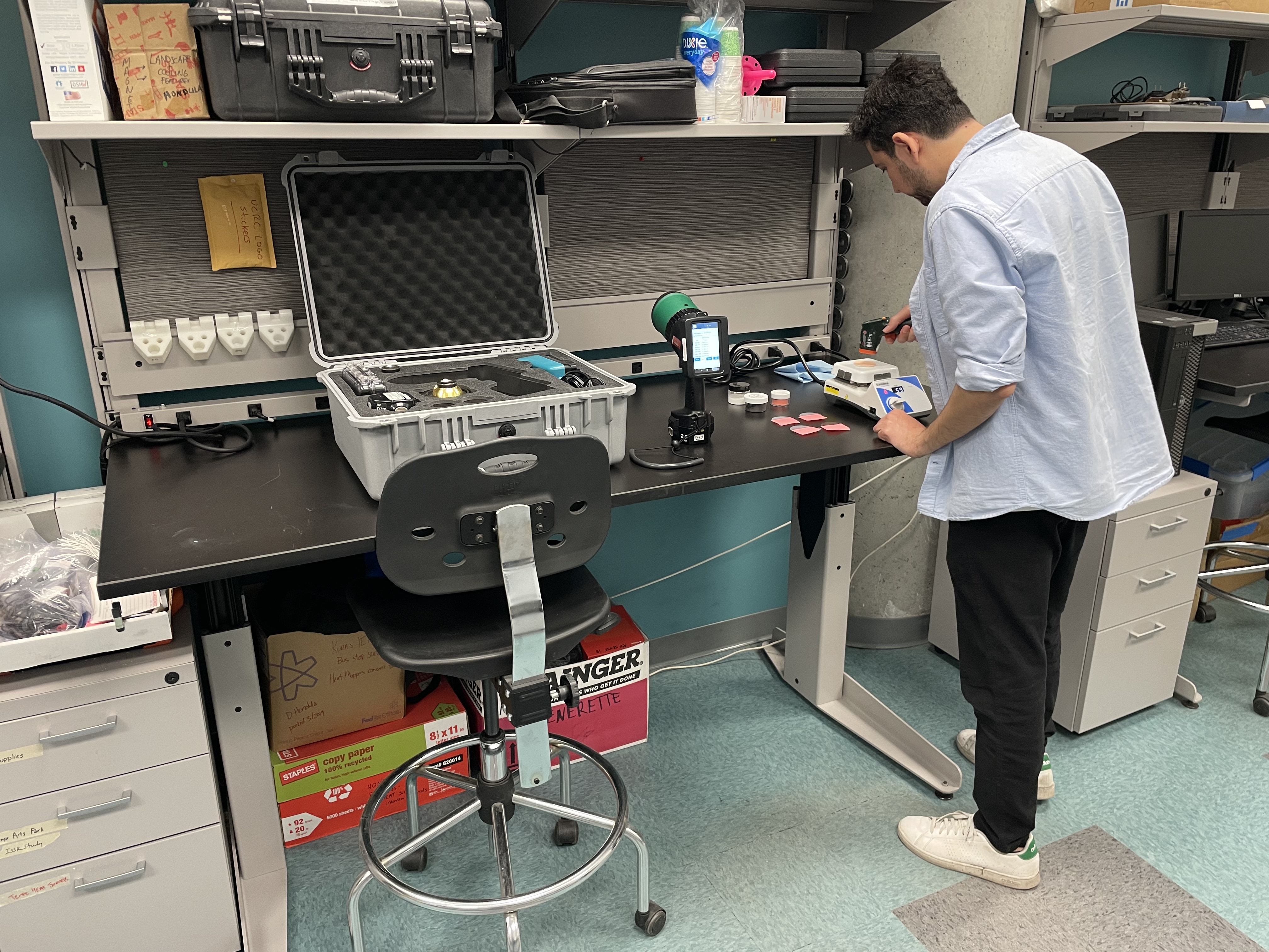 A student standing in a lab working on a project